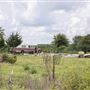 Bus, Concrete Pad, and Cars in Field off Hwy 10
